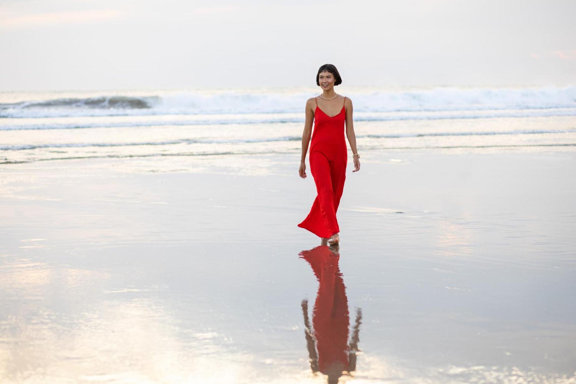 Grand Mercure Bali Seminyak Exterior photo A woman wearing a red dress